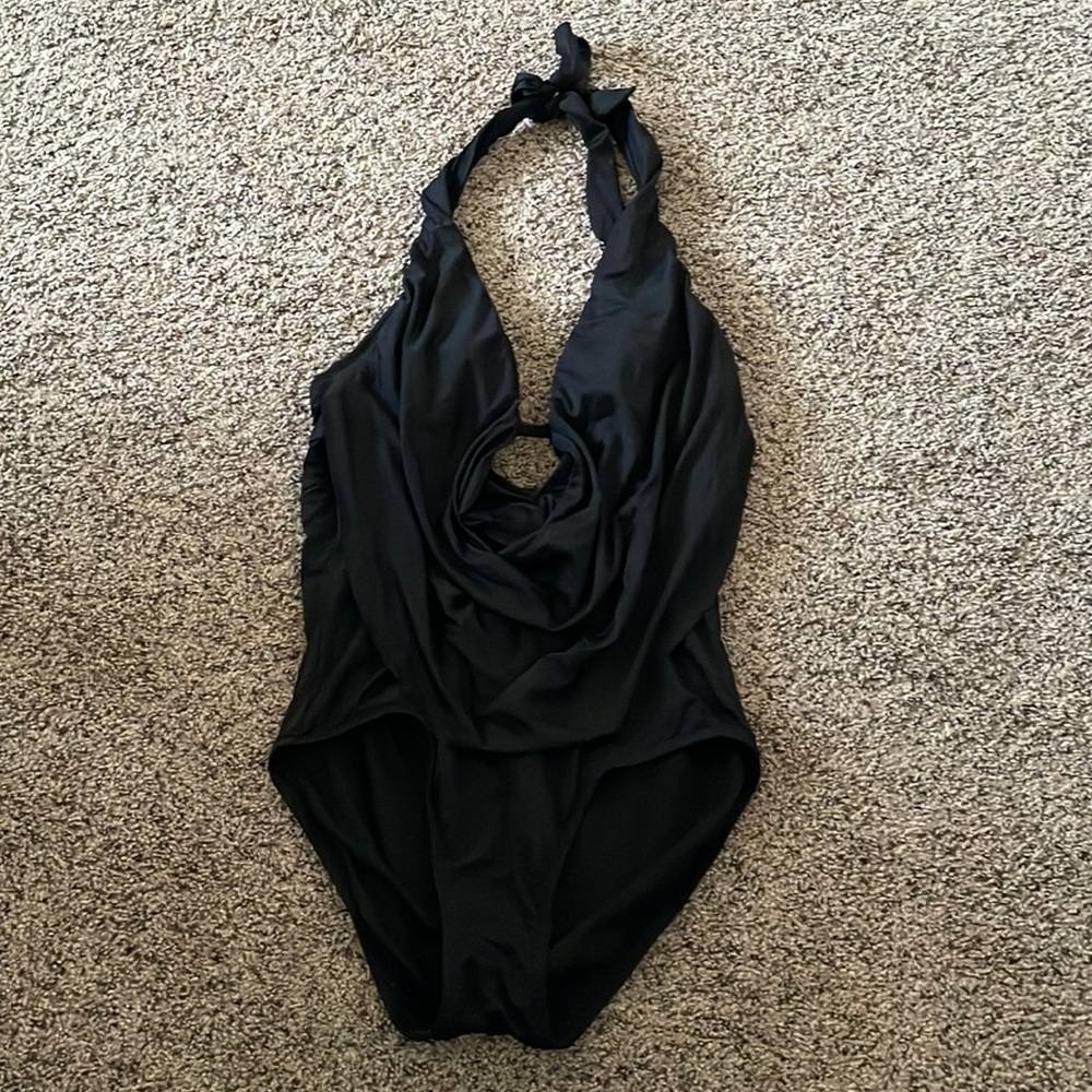 Women’s one piece swimsuit. Worn once. The front is low cut with padded cups.